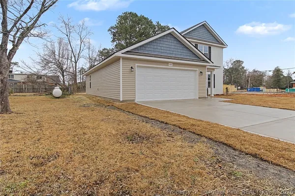 a front view of a house with a yard and garage