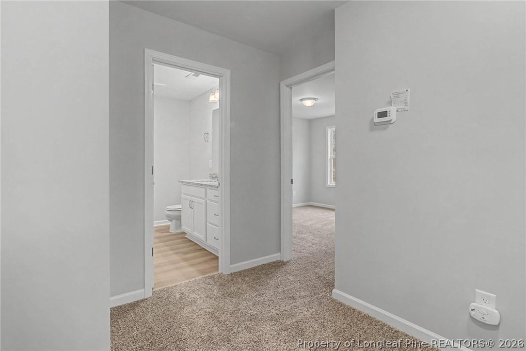 402 Rutherford Street Spring Lake, NC 28390 - Photo 22 of 34 an empty room with wooden floor and mirror