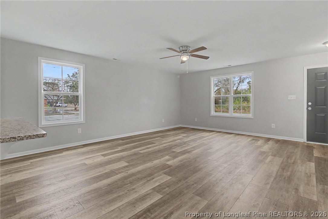 402 Rutherford Street Spring Lake, NC 28390 - Photo 5 of 34 a view of empty room with wooden floor and fan