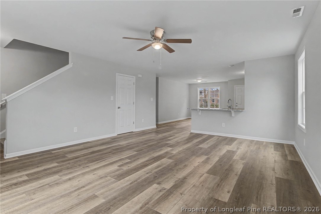 402 Rutherford Street Spring Lake, NC 28390 - Photo 7 of 34 a view of empty room with wooden floor and fan
