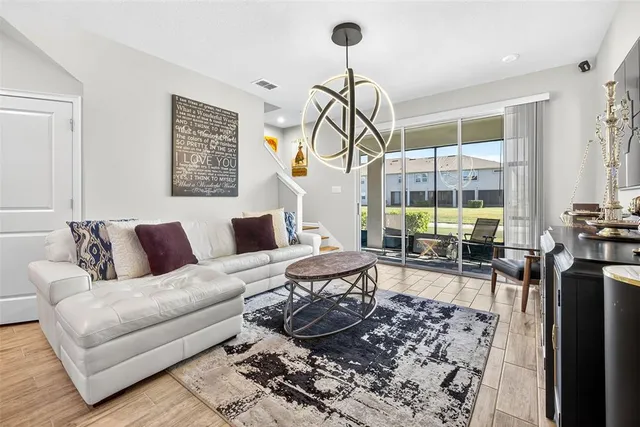 a living room with furniture a rug and white walls