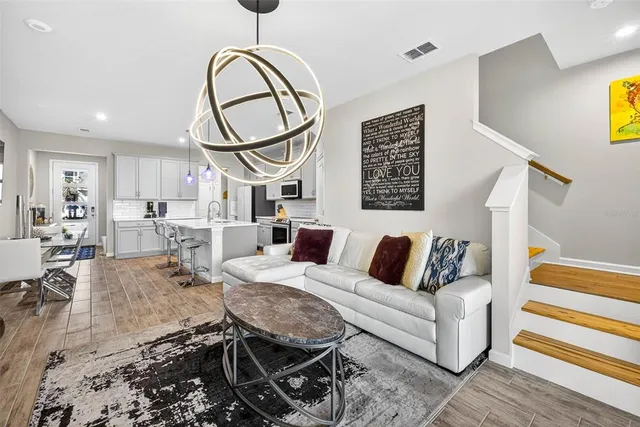 a living room with furniture a rug and white walls