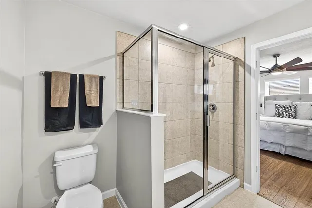 a bathroom with a shower and toilet
