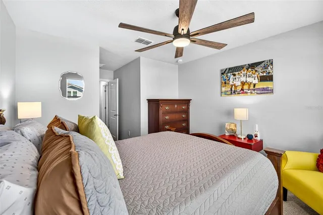 a bedroom with a bed and a chandelier