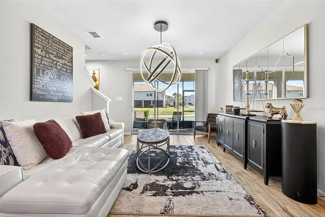 a living room with furniture a rug and white walls