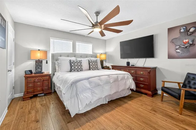 a bedroom with a bed and a flat screen tv