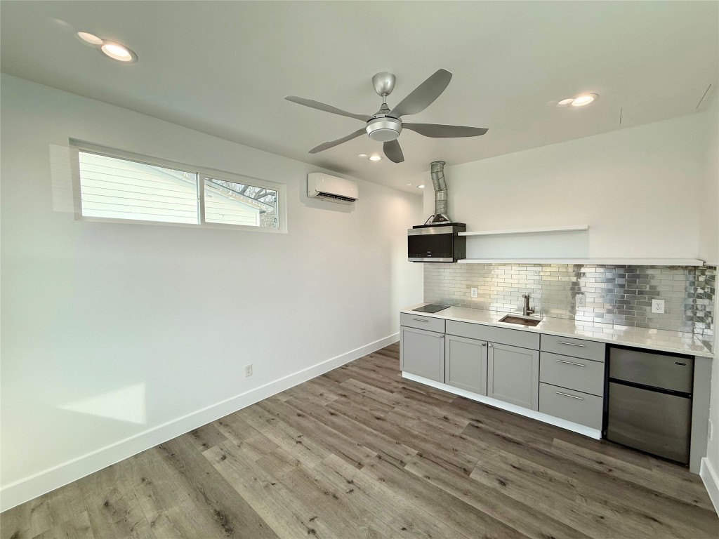 3919 East 16th Street, Unit 1 Austin, TX 78721 - Photo 5 of 11 a kitchen with granite countertop a sink stainless steel appliances and cabinets