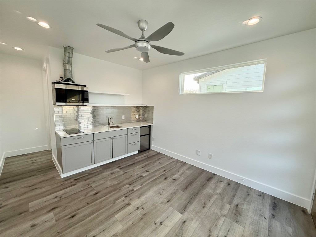 3919 East 16th Street, Unit 1 Austin, TX 78721 - Photo 6 of 11 a kitchen with a stove cabinets and wooden floor