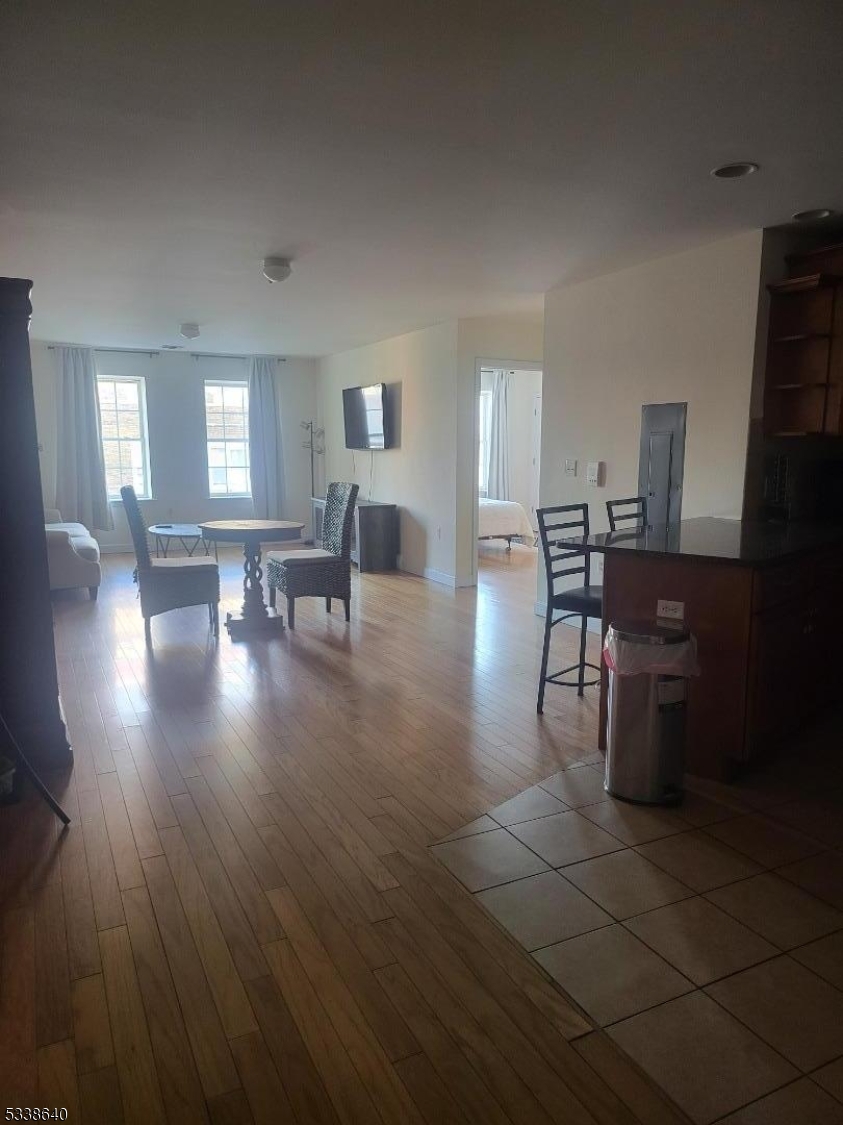 115 Ferry Street, Unit 3A Newark, NJ 07105 - Photo 2 of 10 a view of a dining room with furniture window and wooden floor