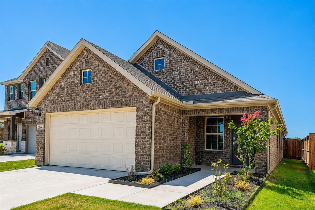 3344 Duncan Way Corinth, TX 76210 - Photo 2 of 38 Brick facade residential property featuring a prominent garage, covered front entry, and gabled rooflines