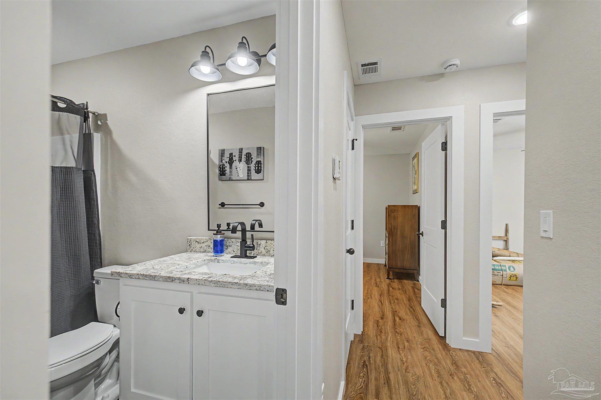 2549 Ten Mile Road Pace, FL 32571 - Photo 21 of 46 a bathroom with a sink a toilet and shower