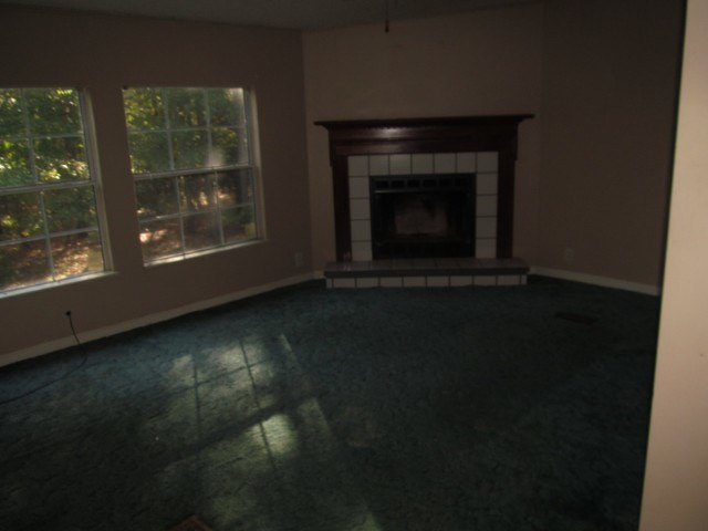 170 Hamlin Road Jackson, GA 30233 - Photo 2 of 6 a view of an empty room with wooden floor and a fireplace