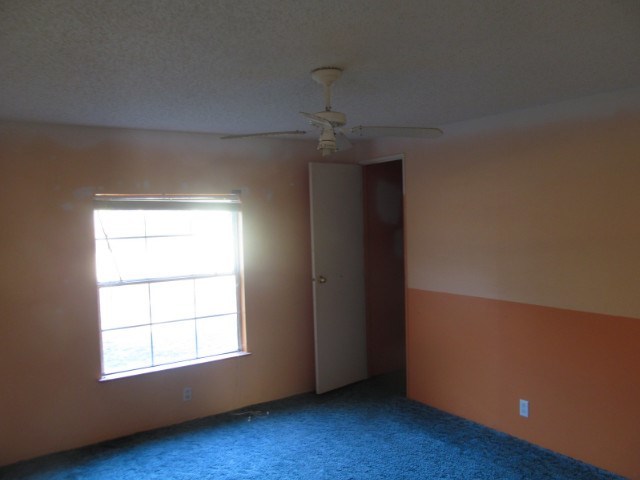 170 Hamlin Road Jackson, GA 30233 - Photo 5 of 6 an empty room with wooden floor cabinet and windows