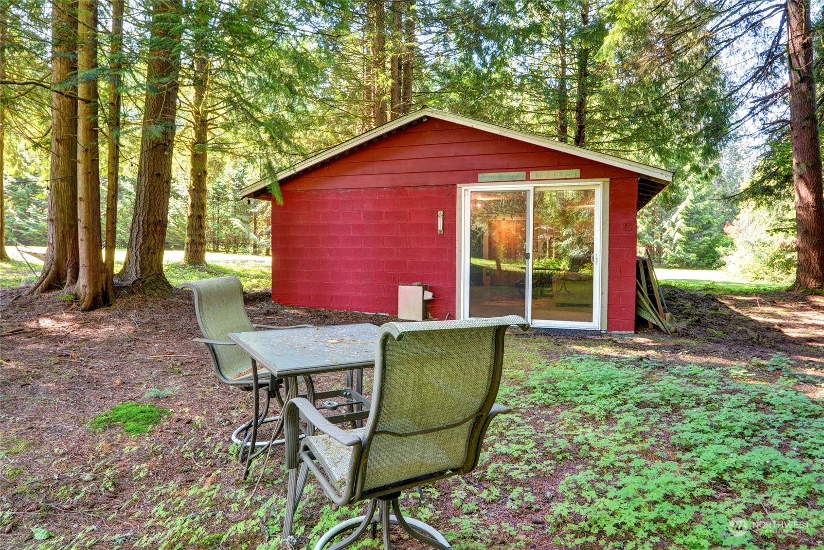 4608 Strumme Road Bothell, WA 98012 - Photo 25 of 30 a view of a backyard with table and chairs and a barbeque