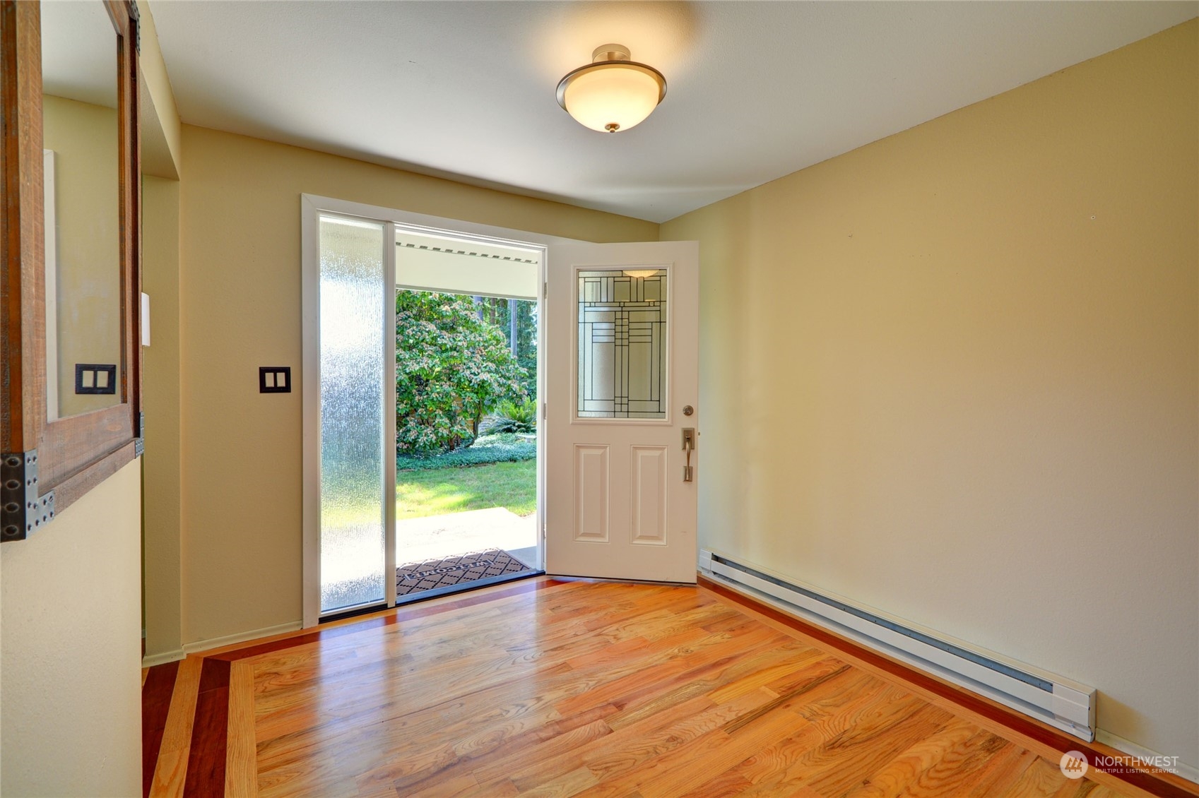 4608 Strumme Road Bothell, WA 98012 - Photo 5 of 30 a view of an empty room with wooden floor and a window