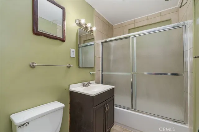 a bathroom with a sink mirror and shower