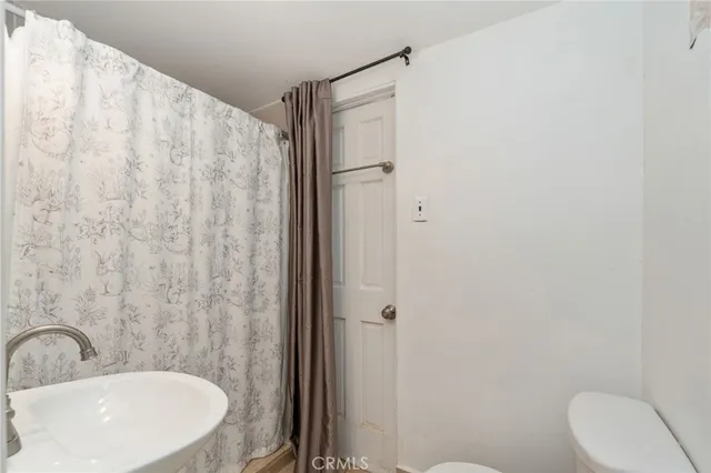 an empty room with closet and windows