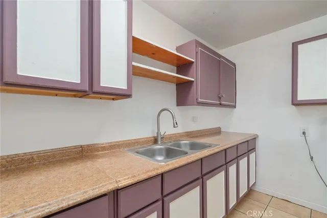 a kitchen with granite countertop a stove top oven sink and cabinets