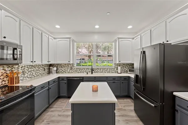 a kitchen with a sink stove and refrigerator