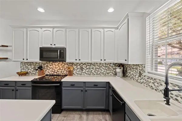 a kitchen with a sink stove and microwave