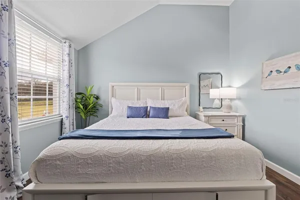 a bedroom with a bed and window