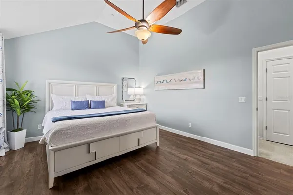 a bedroom with a bed and a potted plant