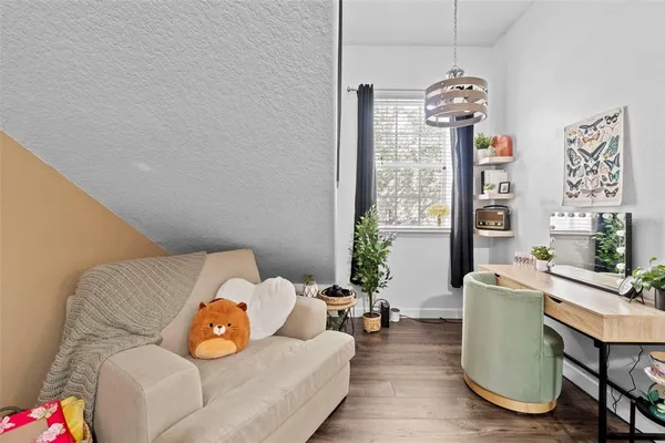 a living room with furniture a chandelier and a window