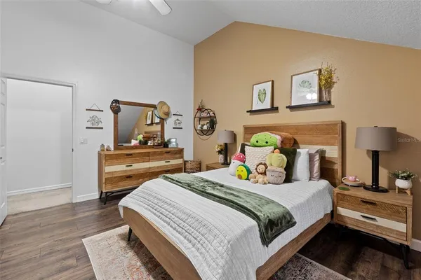 a bedroom with a bed and wooden floor