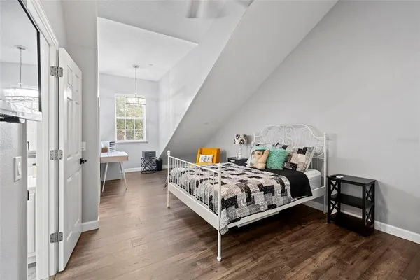 a bed room with a bed and a chair