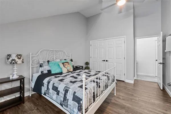 a bedroom with a bed and wooden floor