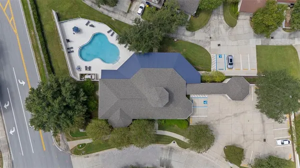 an aerial view of a house with a swimming pool and outdoor seating