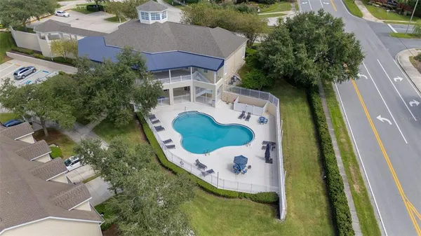 an aerial view of a house with outdoor space pool seating area and lake view