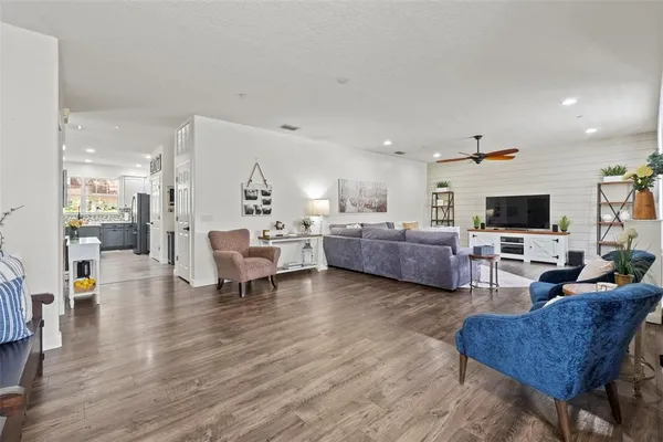 a living room with furniture wooden floor and a flat screen tv