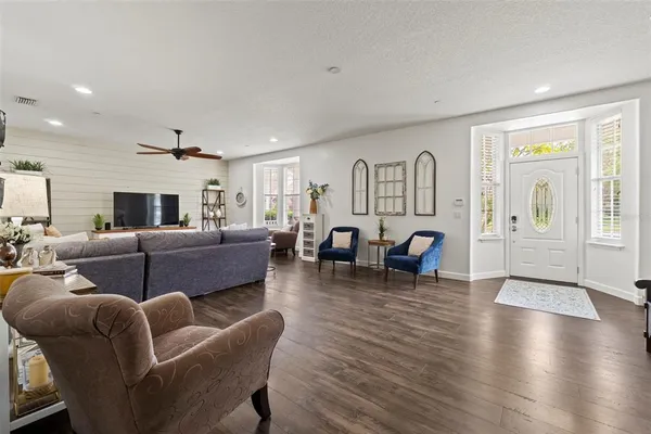 a living room with furniture and a wooden floor
