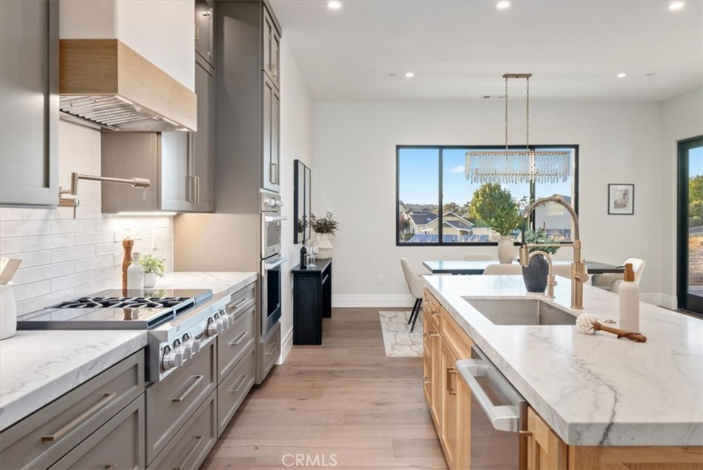 1410 Fire Rock Loop Templeton, CA 93465 - Photo 15 of 64 a kitchen with stainless steel appliances granite countertop a sink stove and cabinets