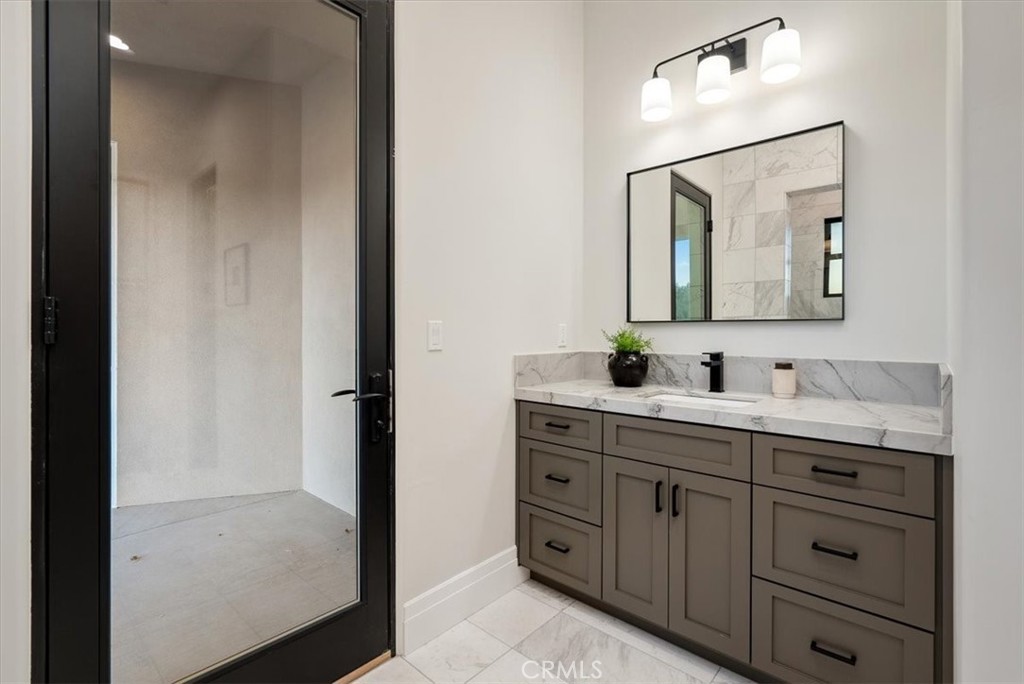 1410 Fire Rock Loop Templeton, CA 93465 - Photo 43 of 64 a bathroom with a double vanity sink and mirror