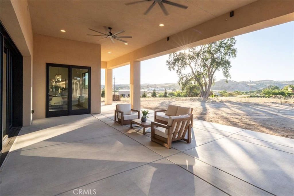 1410 Fire Rock Loop Templeton, CA 93465 - Photo 51 of 64 a living room with patio furniture and a floor to ceiling window