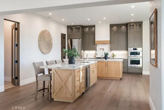 a large kitchen with a table and chairs