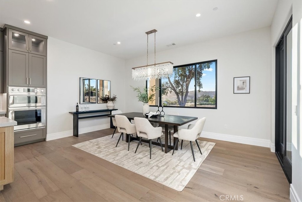 1410 Fire Rock Loop Templeton, CA 93465 - Photo 10 of 64 a view of a dining room with furniture window and wooden floor