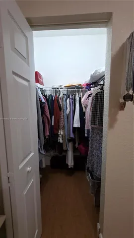 a bathroom with a granite countertop sink mirror vanity and toilet