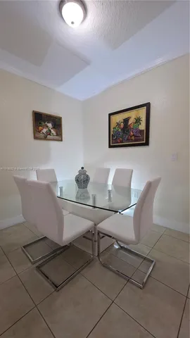 a view of a dining room with furniture and window