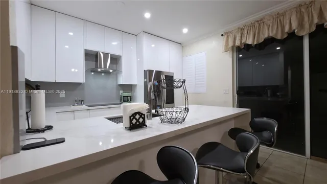 a kitchen with stainless steel appliances a refrigerator and a sink