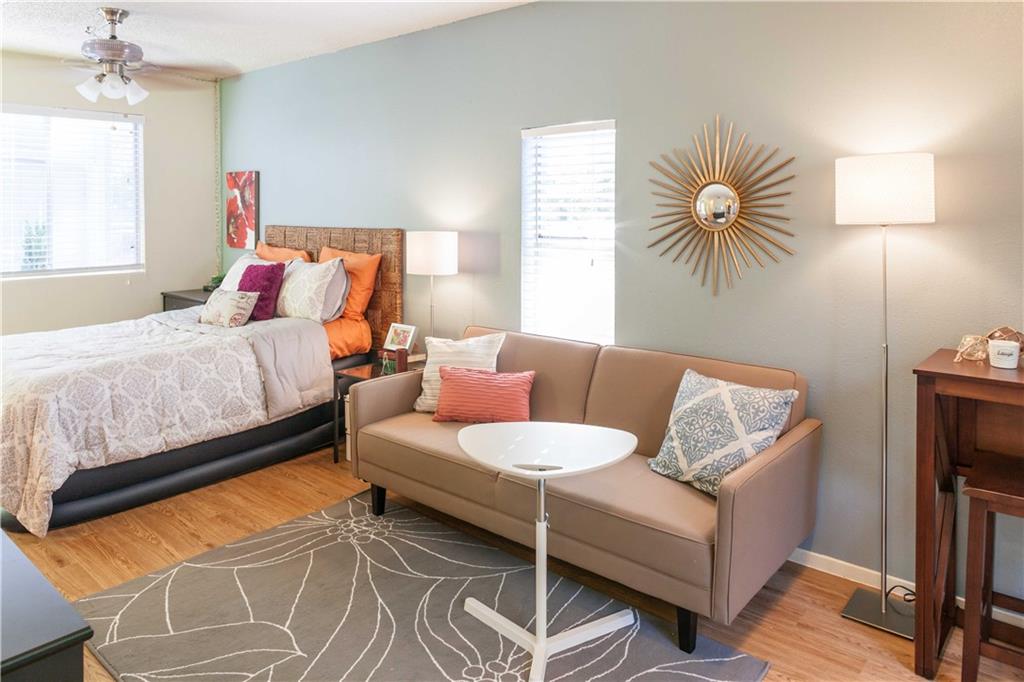 4209 Avenue B, Unit 110 Austin, TX 78751 - Photo 3 of 10 a bedroom with a bed and a couch