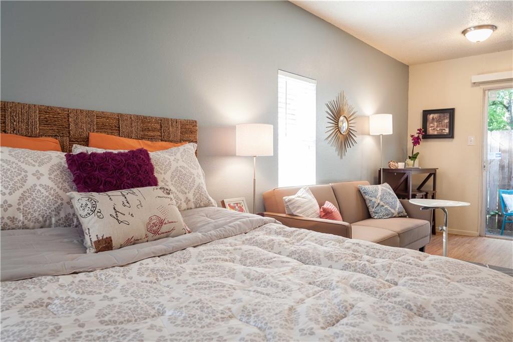 4209 Avenue B, Unit 110 Austin, TX 78751 - Photo 8 of 10 a bedroom with a large bed and a couch