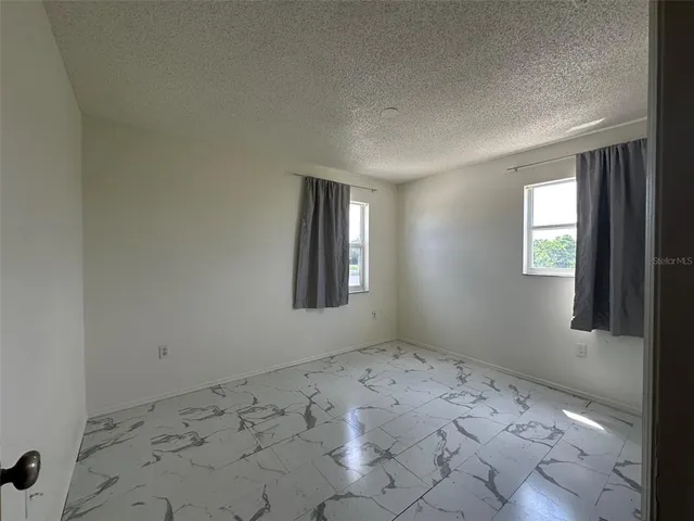 a bathroom with a sink a toilet a mirror and shower