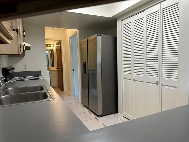 a kitchen with a refrigerator and a sink