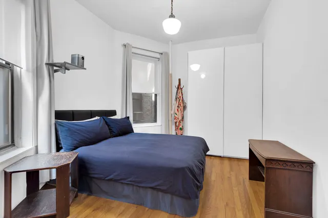 a living room with furniture kitchen view and a window