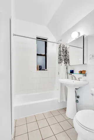 a view of a kitchen with a stove wooden floor and a window