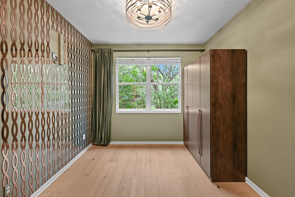 2823 Lantana Ridge Drive Austin, TX 78732 - Photo 15 of 34 a view of empty room with wooden floor and fan