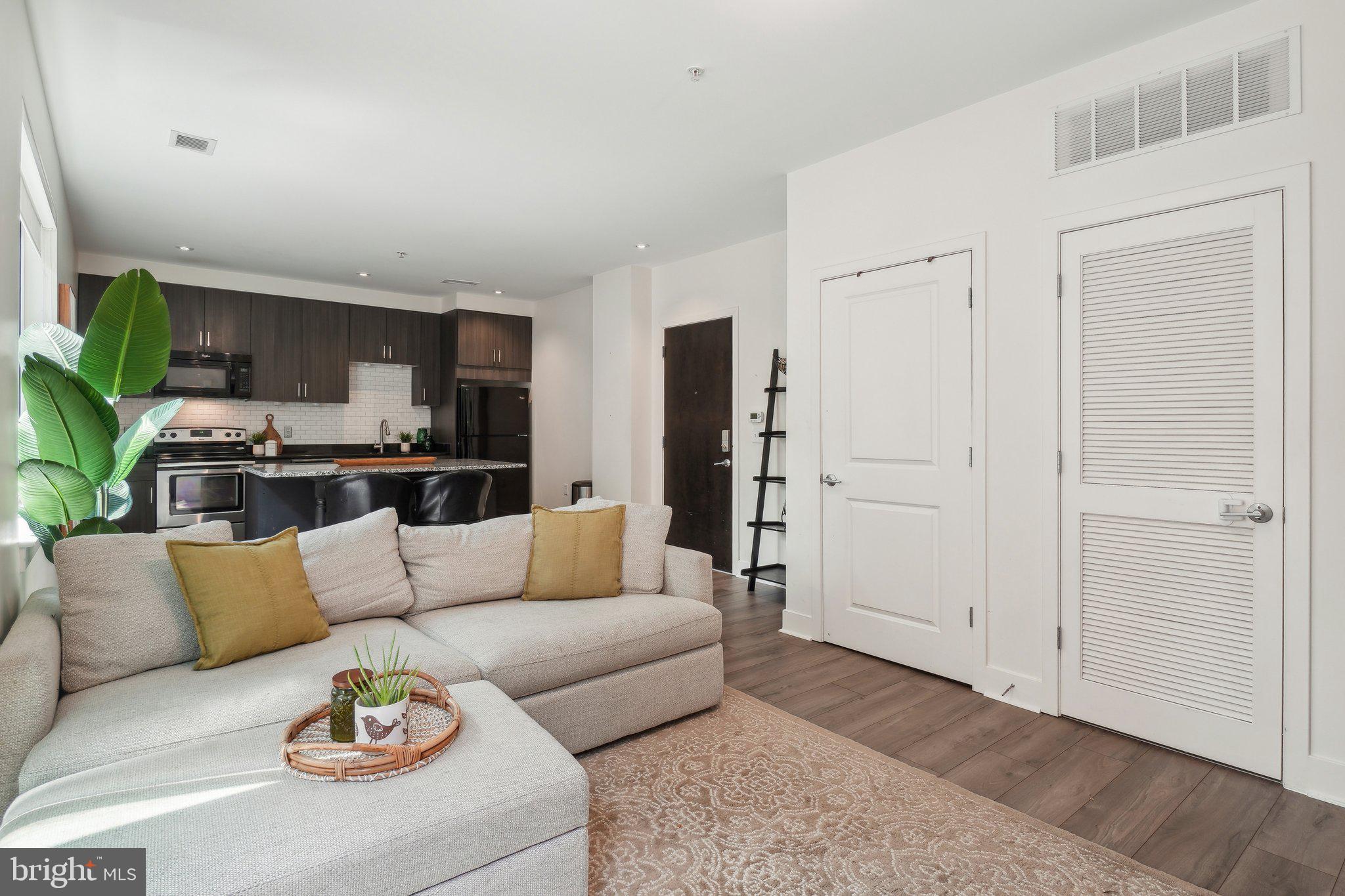 2550 17th Street Northwest, Unit 205 Washington, DC 20009 - Photo 11 of 25 a living room with furniture and a rug